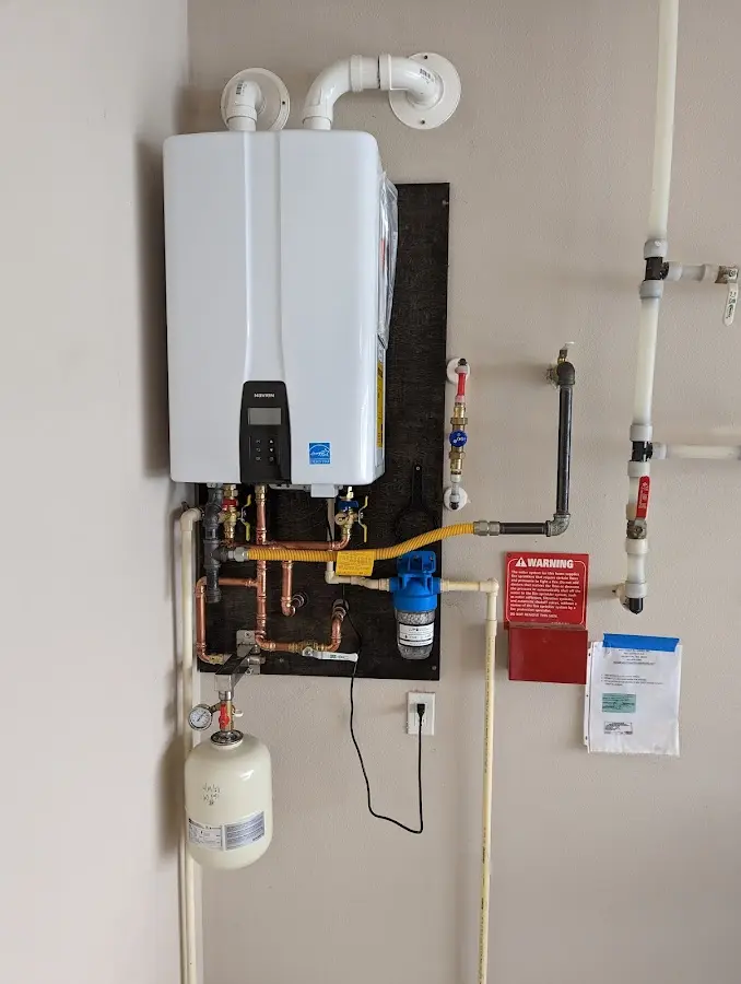 Professional plumber installing copper piping in a North Vernon home